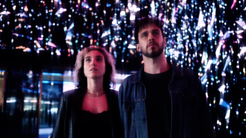 A photo of the band 'Blue Violet'. The background is dark with blurred lights in different colours.